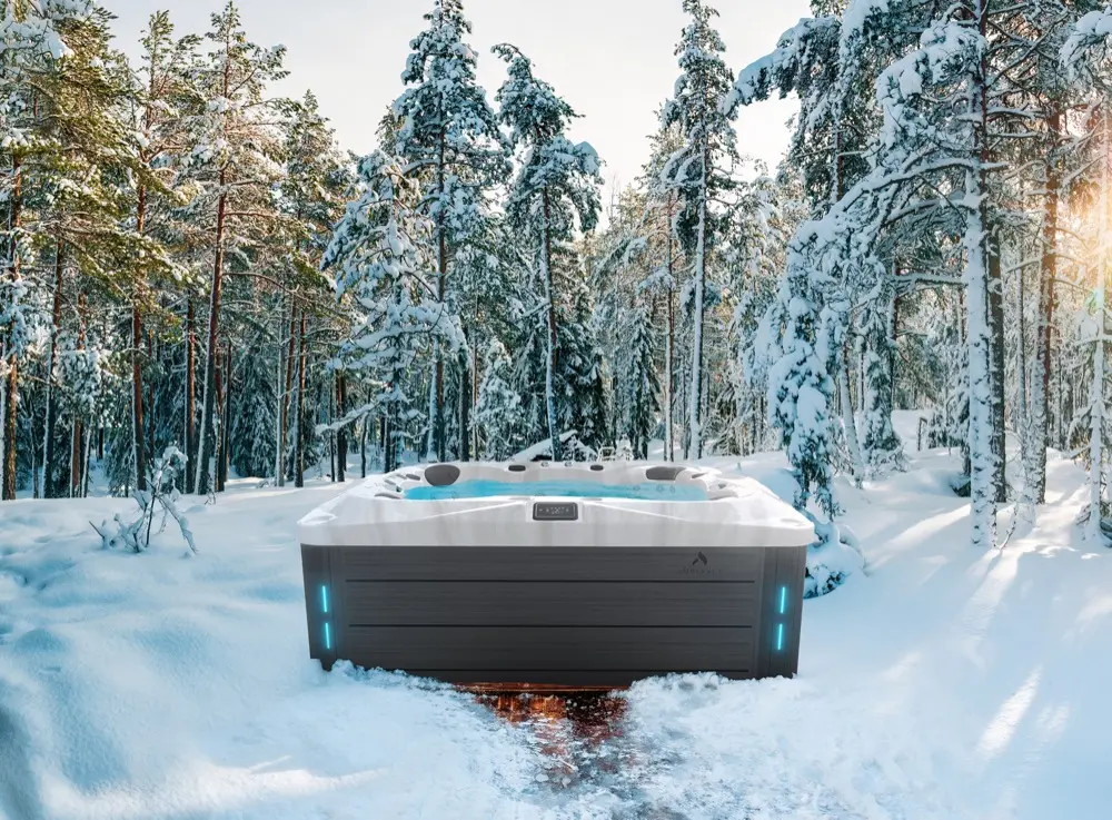 Thermēa spa surrounded by snow with golden sunlight through trees